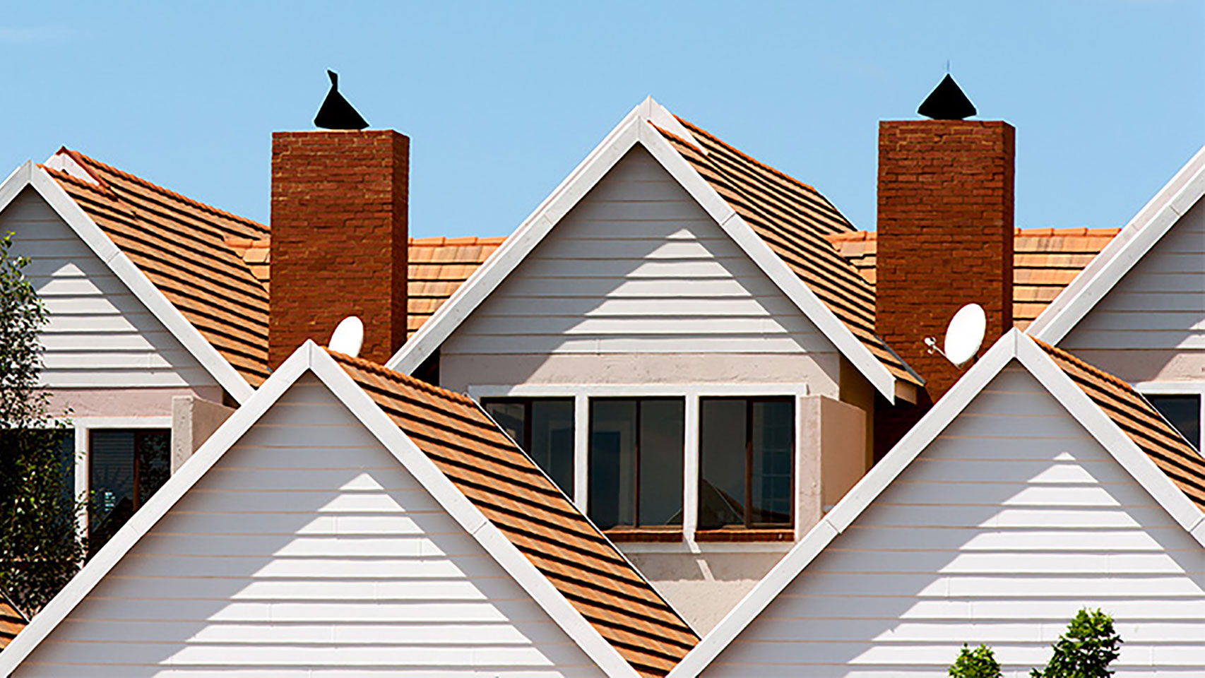 View of condo complex roofs and chimneys